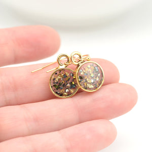 gold abalone shell earrings shown in hand