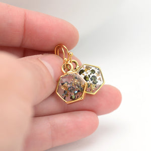 Gold abalone hexagon earrings in hand