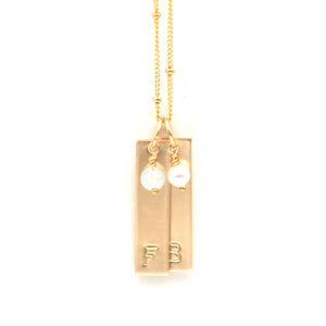 handstamped gold bar necklace with gemstones.