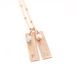 handstamped gold bar necklace with gemstones.