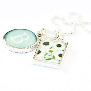 Daisy and intial charms closeup