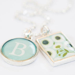 Closeup daisy and intial charms