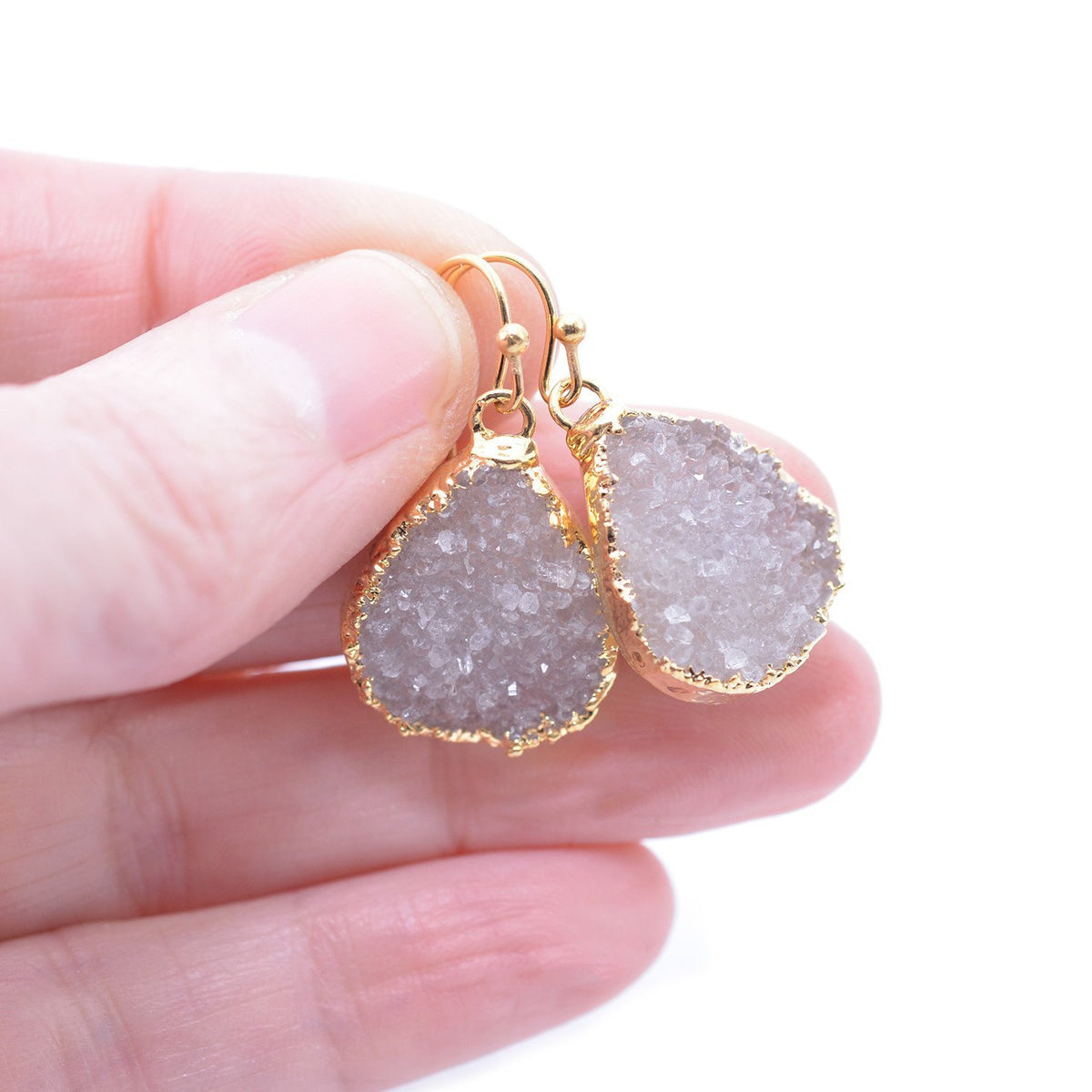 Gold plated teardrop druzy earrings in hand