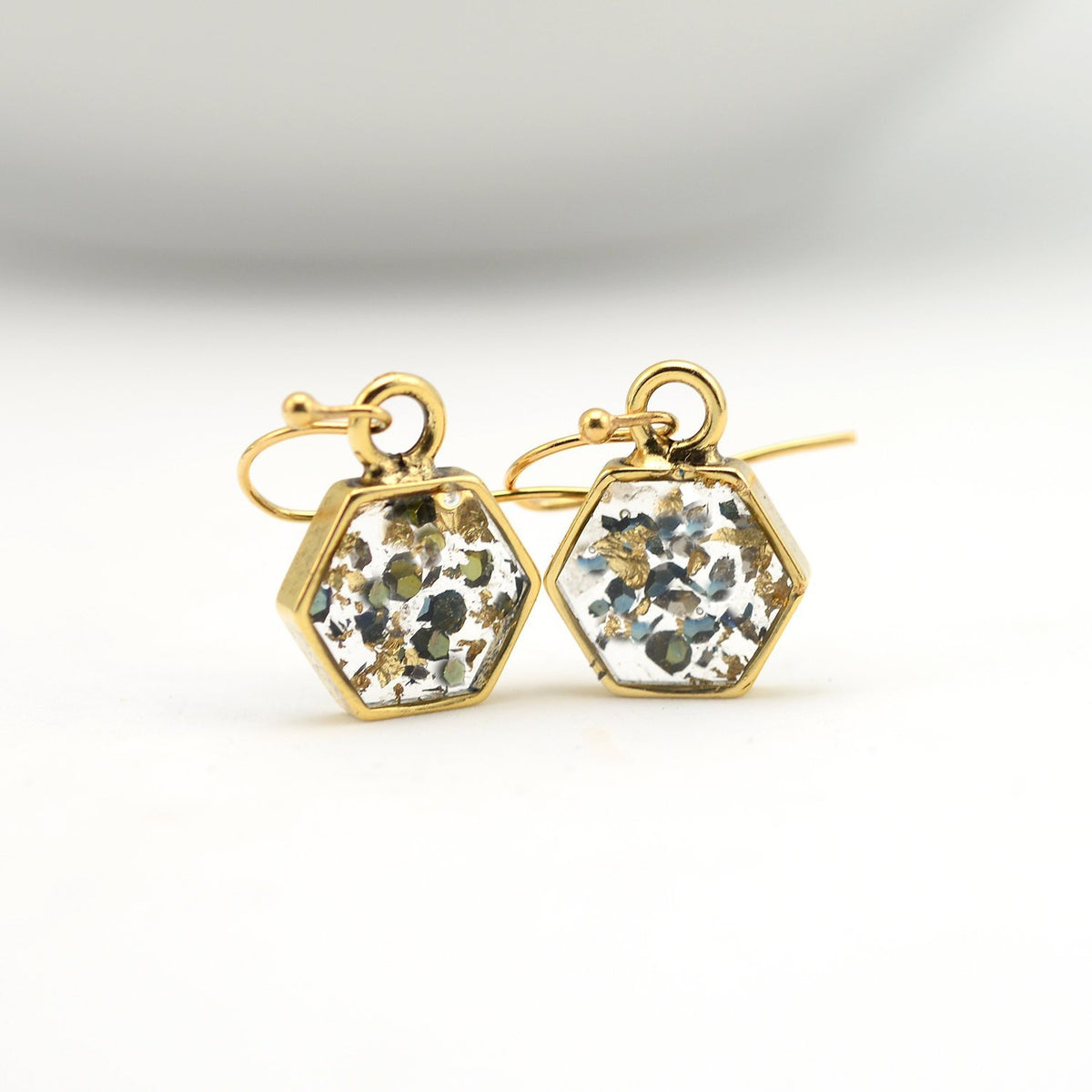 Closeup gold abalone shell hexagon earrings