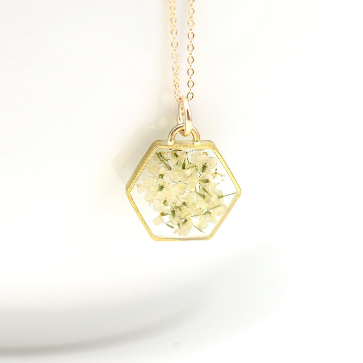 Floral hexagon necklace in gold